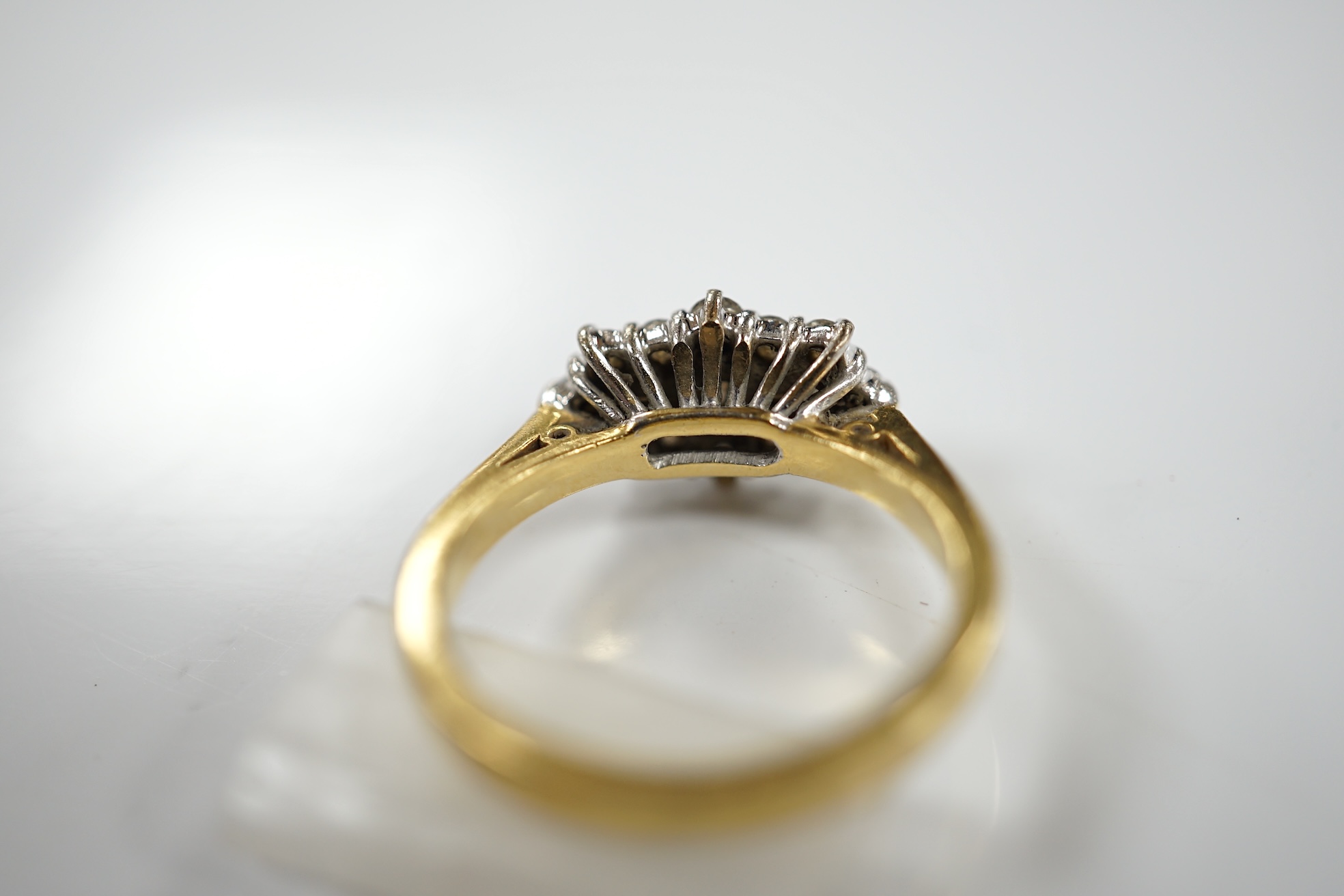 A modern 18ct gold and diamond cluster ring, size K, gross weight 4.4 grams. Condition - fair to good